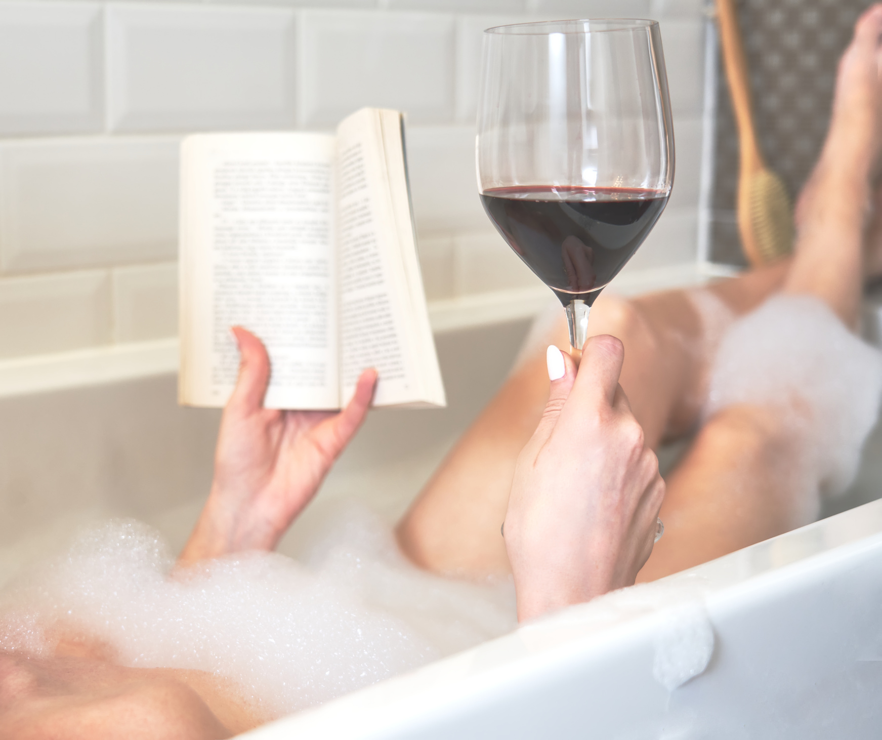Woman Having Wine and Reading Book in the Bath